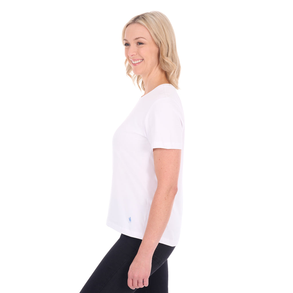 A woman in profile modelling a white Thomas Cook Women's Round Neck Short Sleeve Tee (TCP2515104) paired with blue denim jeans on a white background.