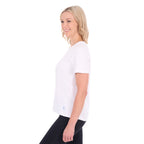 A woman in profile modelling a white Thomas Cook Women's Round Neck Short Sleeve Tee (TCP2515104) paired with blue denim jeans on a white background.