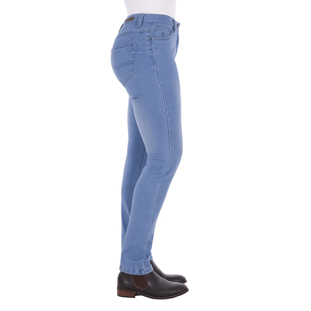 Light wash blue Thomas Cook Women's Suzie Slimmer Leg Jeans 32 Leg (TCP2215128) shown from the side on a model from the waist down, paired with black boots against a plain white background.