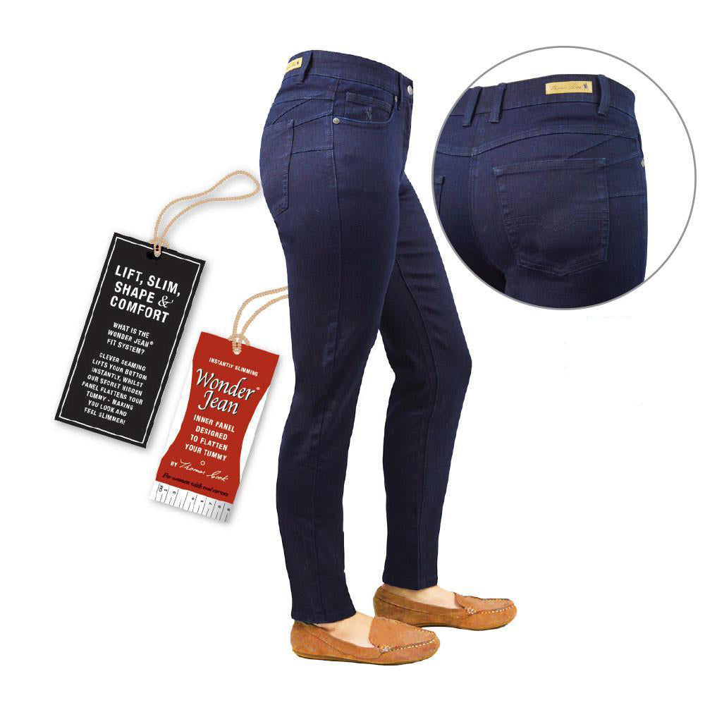 Dark navy blue slim-fit Thomas Cook Women's Suzie Slimmer Leg Wonder Jeans (TCP2220128) (TCP2215128) shown on a ghost mannequin lower body form with tan slip-on flats, plus a circular inset close-up of the back pocket area and two hanging product tags on a white background.