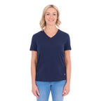 A woman with blonde hair wearing a navy blue Thomas Cook Women's V Neck Short Sleeve Tee (TCP2550105) and denim jeans, standing against a plain white background.