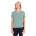 A woman with blonde hair wearing a sage green Thomas Cook Women's V Neck Short Sleeve Tee (TCP2550105) and black pants, standing against a plain white background.