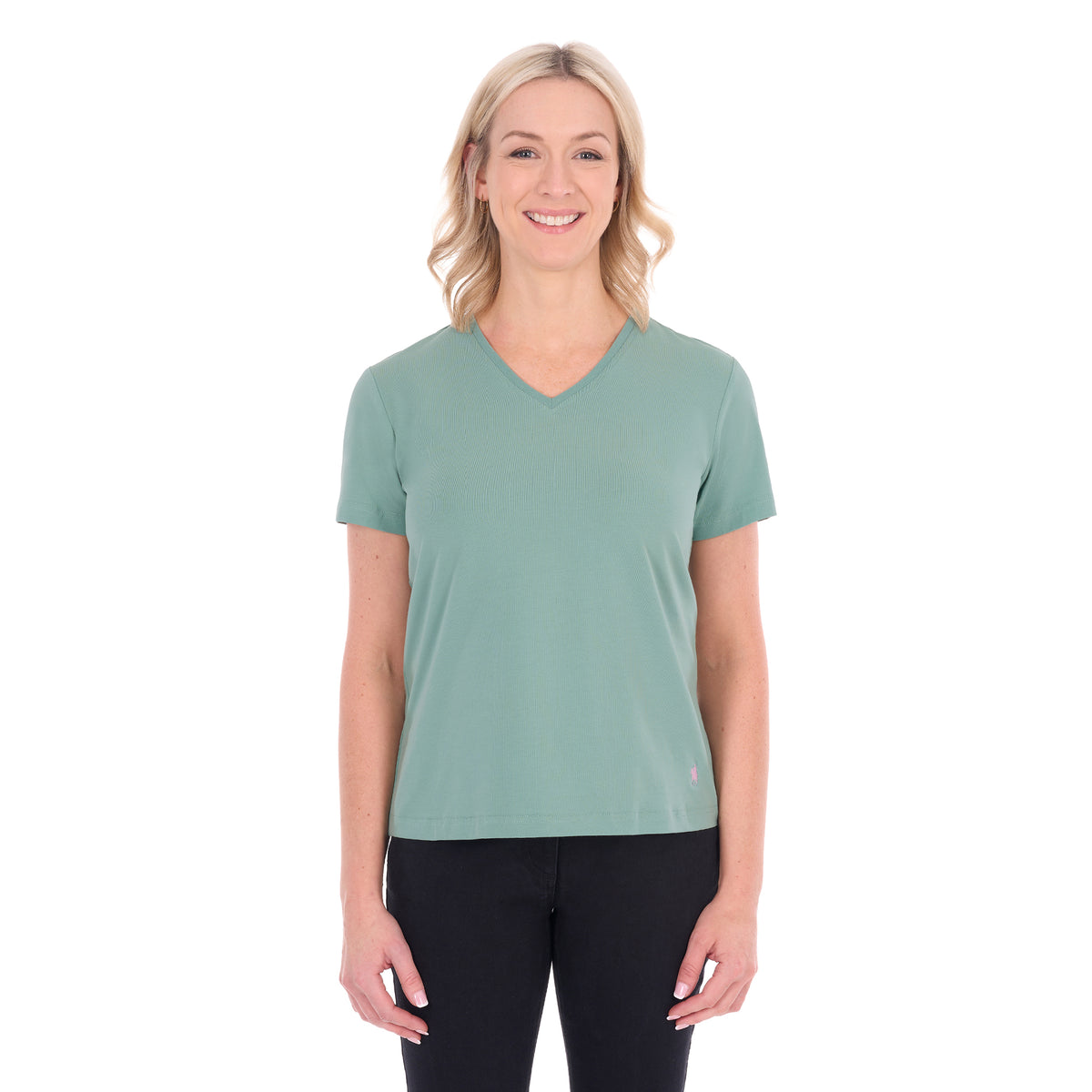 A woman with blonde hair wearing a sage green Thomas Cook Women's V Neck Short Sleeve Tee (TCP2550105) and black pants, standing against a plain white background.