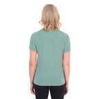 A woman viewed from behind with blonde hair wearing a sage green Thomas Cook Women's V Neck Short Sleeve Tee (TCP2550105) and black pants, standing against a plain white background.