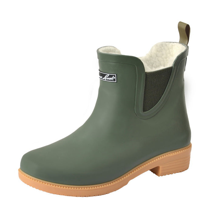 The Thomas Cook Womens Wynyard Gumboots (T6W28503) in Dark Khaki feature a green ankle-high design with tan outsole, elastic side panel, back pull tab, and soft white faux fur lining for comfort.