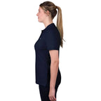 A woman in profile wearing a navy blue Thomas Cook Women's Classic Stretch Short Sleeve Polo with a Thomas Cook embroidered logo on a white background.