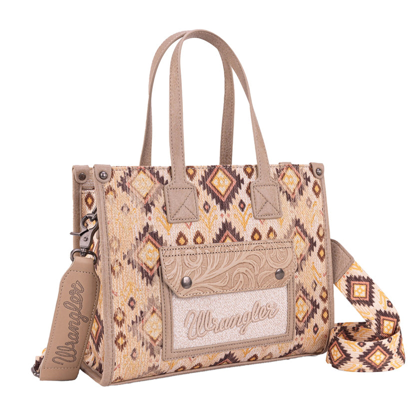 The Wrangler Aztec Crossbody Tote Bag (X6W4918BAG) in camel features a beige and brown Aztec pattern, dual handles, an adjustable canvas crossbody strap, and a front pocket with "Wrangler" embroidered on a leather patch.