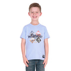 A smiling young boy wearing a light blue Wrangler Boys Mark Short Sleeve Tee (X6S3557688) with a graphic print on the front, paired with dark blue jeans, photographed against a solid white background.
