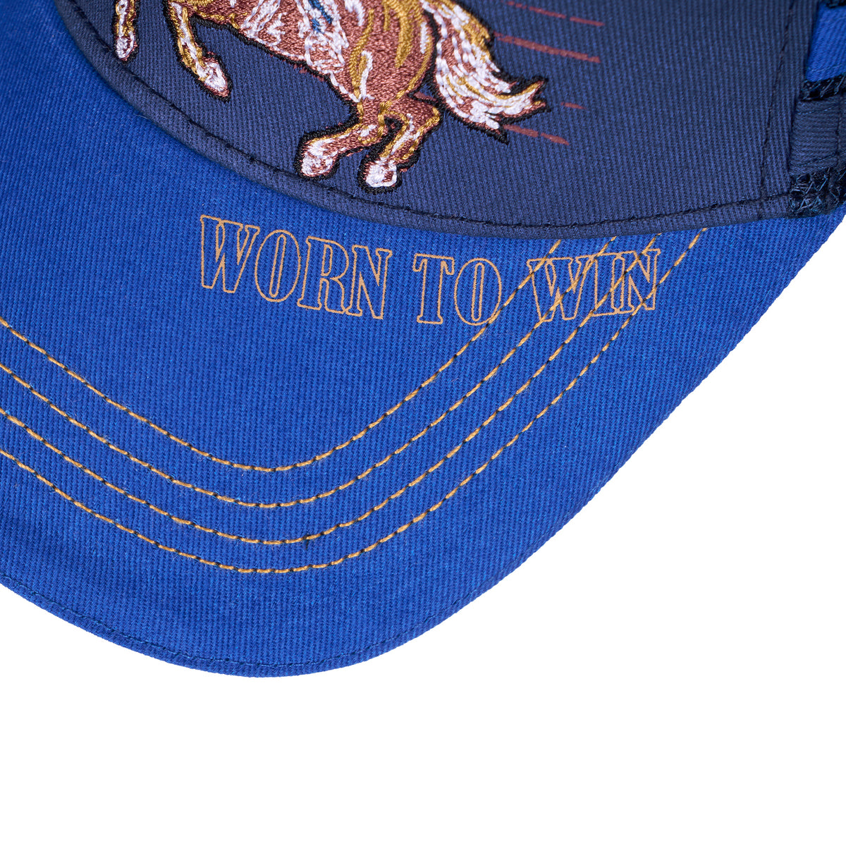 Brim view of a navy/blue Wrangler Children's Abe Trucker Cap (X6S3946CAP) with printing and contrast stitching and a western cowboy embroidered on the front panel.