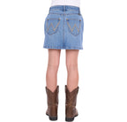 A girl shown from the back wearing a faded blue Wrangler Girls Grace Skirt (X6S5202720) with decorative stitching and brown cowboy boots, against a plain white background.