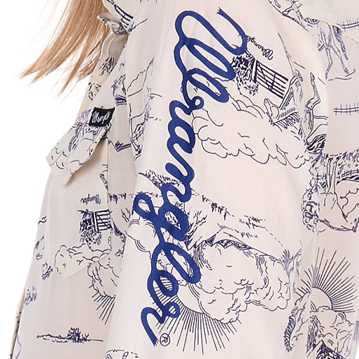 A close up of the Wrangler logo sleeve print on the Wrangler Girls Ivory Logo Long Sleeve Shirt (X6S5127602).