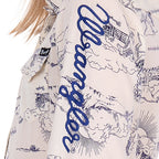 A close up of the Wrangler logo sleeve print on the Wrangler Girls Ivory Logo Long Sleeve Shirt (X6S5127602).