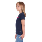 A young girl in profile with blonde hair wearing a navy blue Wrangler Girls Maya T-Shirt (X6S5598649) and blue jeans, standing against a plain white background.
