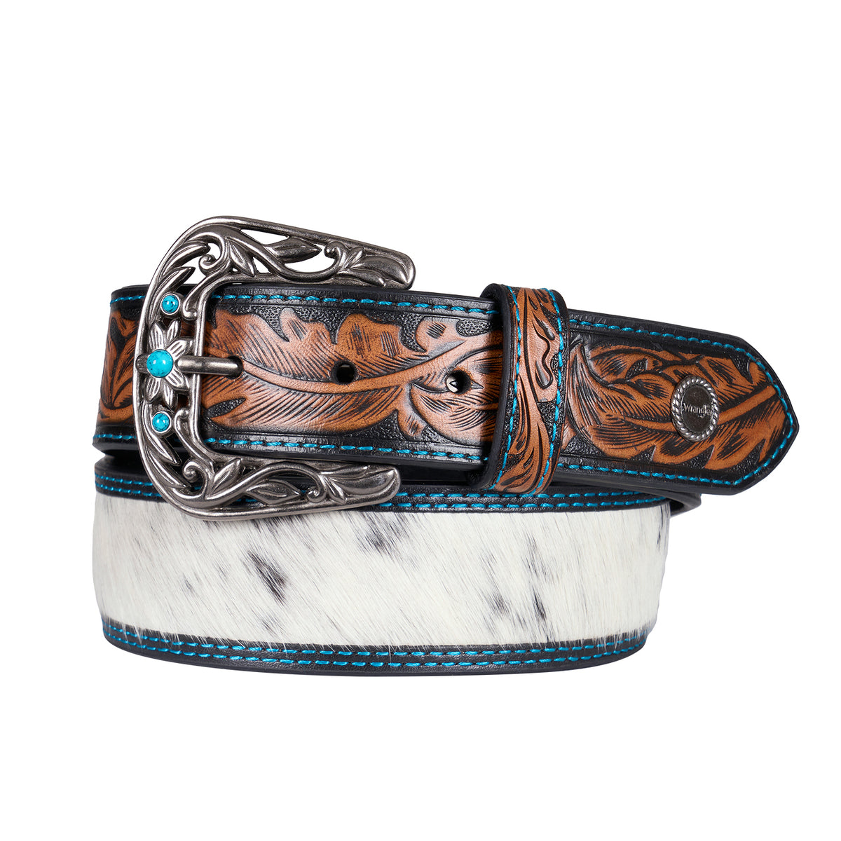 The tan western-style Wrangler Kenzley Belt (X6S2917BLT) rolled up, featuring a brown tooled leather strap with turquoise blue edge stitching, a white and black hair-on-hide centre panel, and an ornate silver toned buckle embellished with turquoise stones.