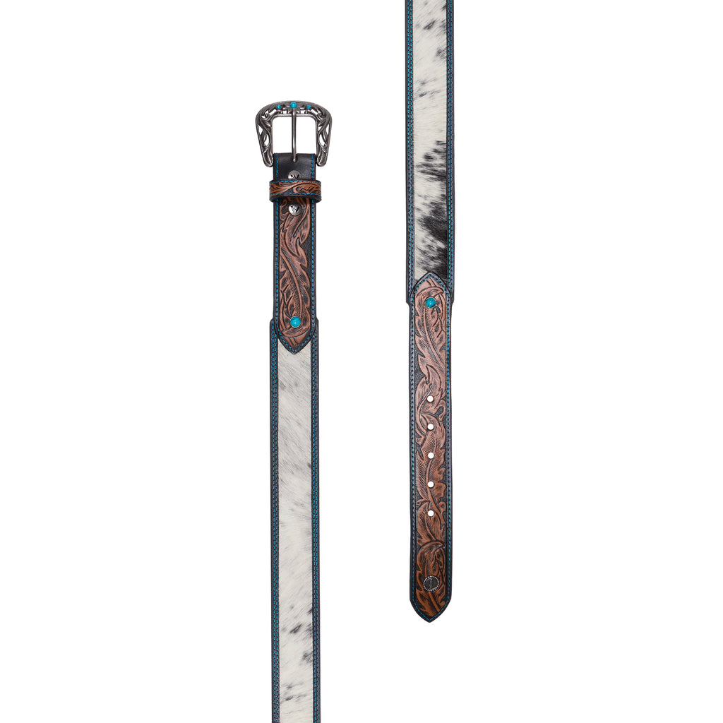 The tan western-style Wrangler Kenzley Belt (X6S2917BLT) flat laid, featuring a brown tooled leather strap with turquoise blue edge stitching, a white and black hair-on-hide centre panel, and an ornate silver toned buckle embellished with turquoise stones. 