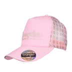 A pastel pink Wrangler Lucy High Profile Ponytail Trucker Cap (X6S2937CAP) with a pink front panel, glittery script logo, and patterned mesh back panels on a white background.