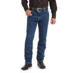 A person in a black long-sleeve shirt, Wrangler Men's Cowboy Cut Original Fit Active Flex Jeans (13MAFGK34) Stonewash, a black belt with a large buckle, and black cowboy boots stands against a white background. Head not visible.