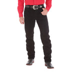 Person wearing black jeans with a red shirt on a white background with a western belt and black boots.