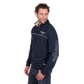 Man wearing a Wrangler Mens Dale 1/4 Zip Pullover (X6W1573509) in navy, featuring a quilted yoke and logo on chest and sleeve, stands with one hand by his side, looking slightly to his left.