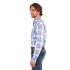 A man in profile wearing a light blue, royal blue and white Wrangler Men's Eric long-sleeve western-style plaid button-down Shirt (X6S1111667) paired with dark blue jeans, set against a plain white background.