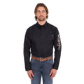 A man wearing a black Wrangler Men's Flex Logo Long Sleeve Shirt (XCP1155359) with a light tan Wrangler Onyx Belt (X6S1969BLT) and blue jeans, standing against a solid white background.