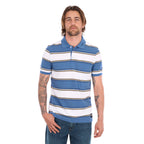 A man wearing a denim blue and white Wrangler Men's Mick Short Sleeve Polo (X6S1560679) with thin tan stripes, paired with blue jeans, photographed against a solid white background.