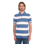 A man wearing a denim blue and white Wrangler Men's Mick Short Sleeve Polo (X6S1560679) with thin tan stripes, paired with blue jeans, photographed against a solid white background.
