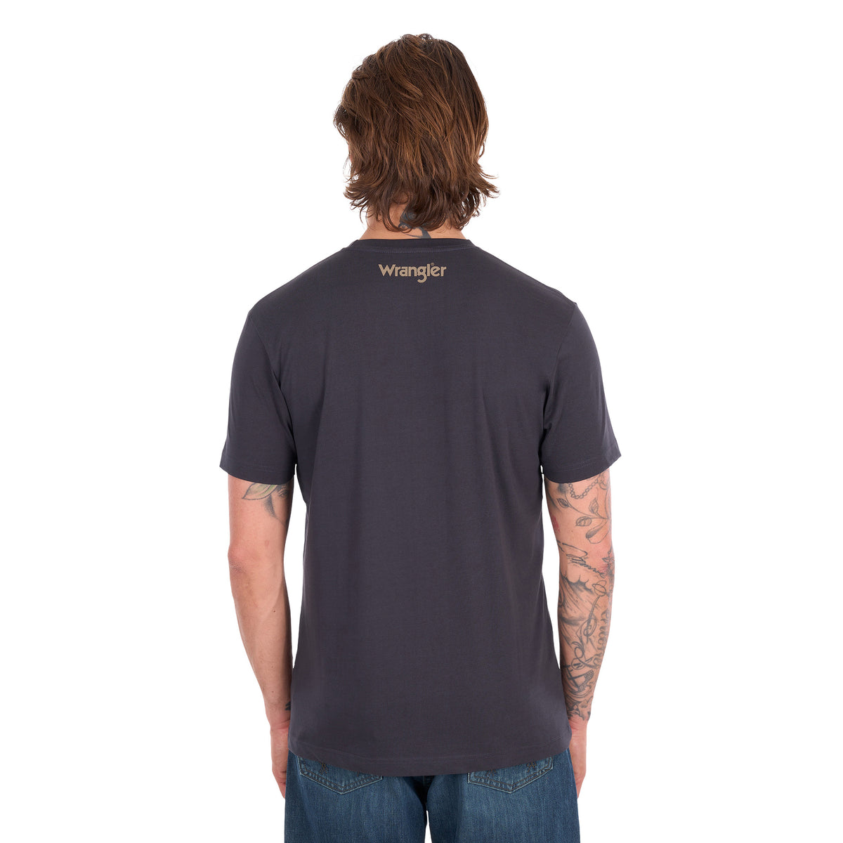 A man with his back to the camera wearing a charcoal Wrangler Men's Tim Short Sleeve Tee (X6S1557696) with a Wrangler back neck print logo, paired with blue jeans, standing against a plain white background.