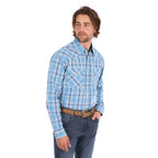 A man wearing a teal and tan Wrangler Men's Zak L/S Shirt (X6S1111668) with a brown belt and dark blue jeans, standing against a solid white background.