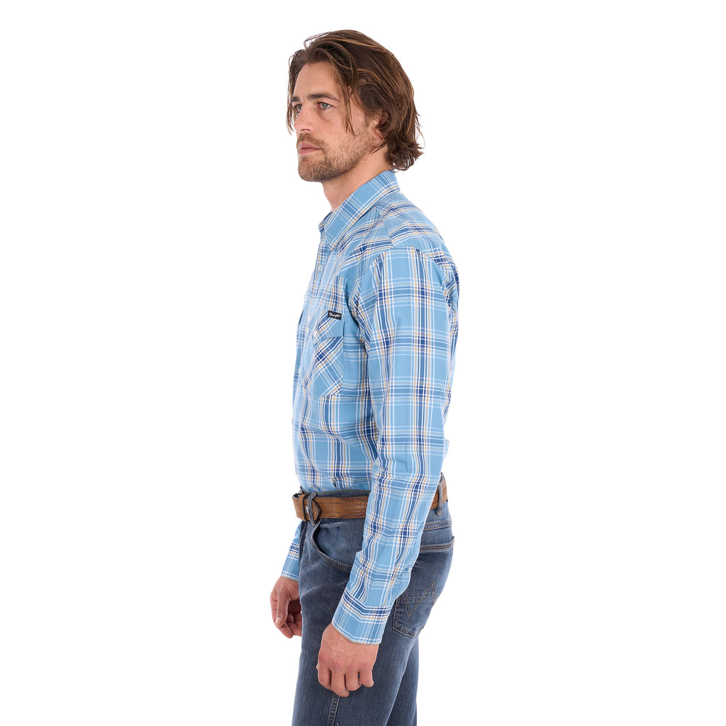 A man wearing a teal and tan Wrangler Men's Zak L/S Shirt (X6S1111668) with a brown belt and dark blue jeans, standing against a solid white background.