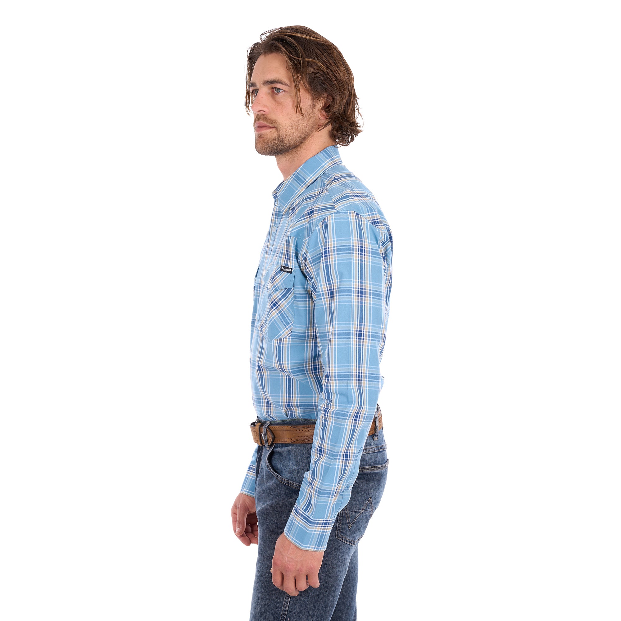 A man wearing a teal and tan Wrangler Men's Zak L/S Shirt (X6S1111668) with a brown belt and dark blue jeans, standing against a solid white background.