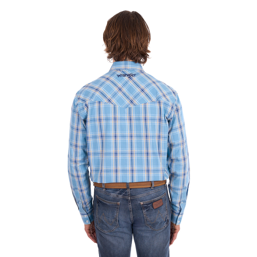 A man wearing a teal and tan Wrangler Men's Zak L/S Shirt (X6S1111668) with a brown belt and dark blue jeans, standing against a solid white background.