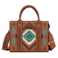 The Wrangler Talia Aztec Crossbody Bag (X6W4907BAG) in tan features dual handles, a shoulder strap, and a vibrant Southwestern Aztec pattern in turquoise, black, and cream. The Wrangler logo is displayed on both the bag and strap.