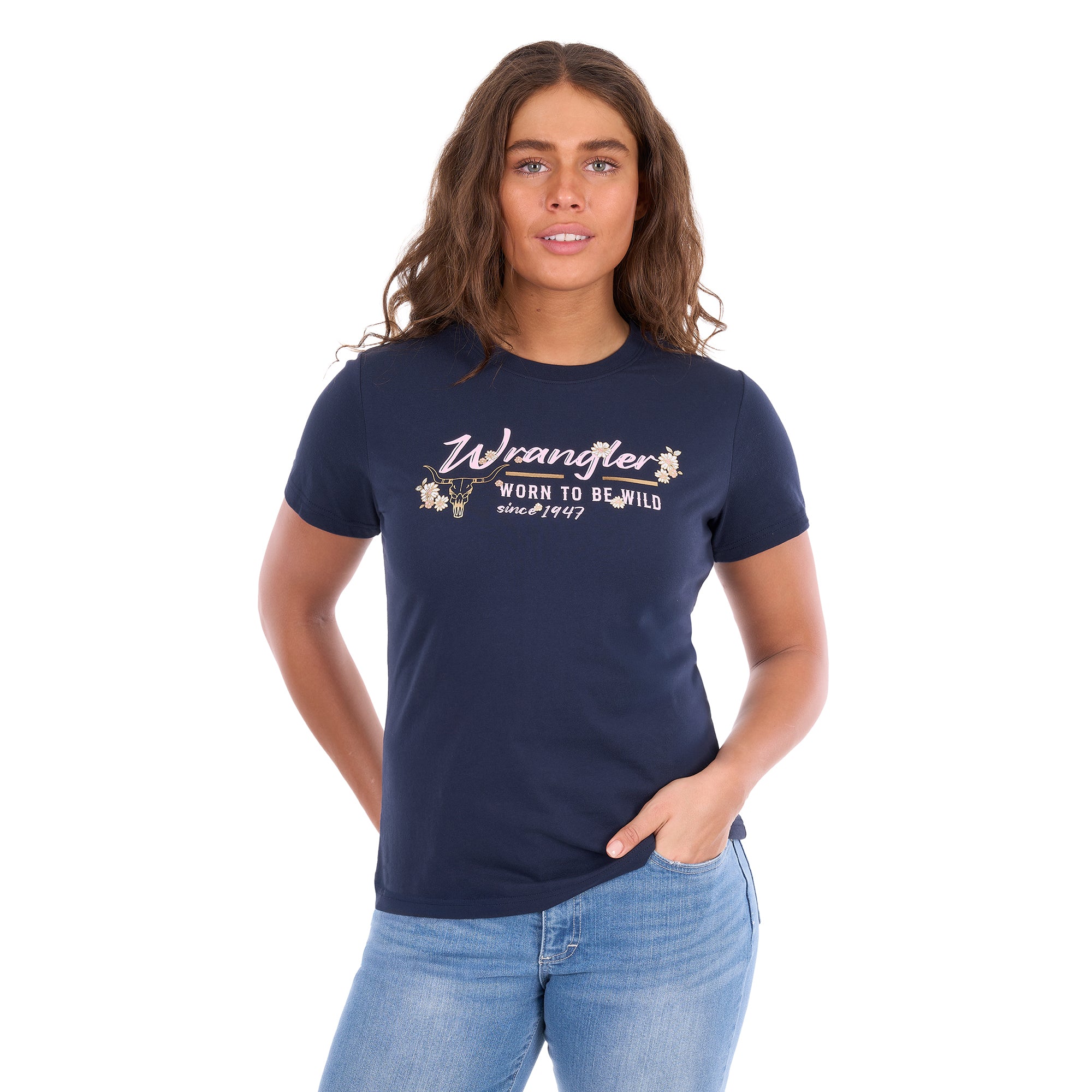 A woman modelling a navy blue Wrangler Belle Tee (X6S2598643) with a yellow and white Wrangler graphic print on the chest, paired with light blue jeans, against a plain white background.