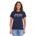 A woman modelling a navy blue Wrangler Belle Tee (X6S2598643) with a yellow and white Wrangler graphic print on the chest, paired with light blue jeans, against a plain white background.