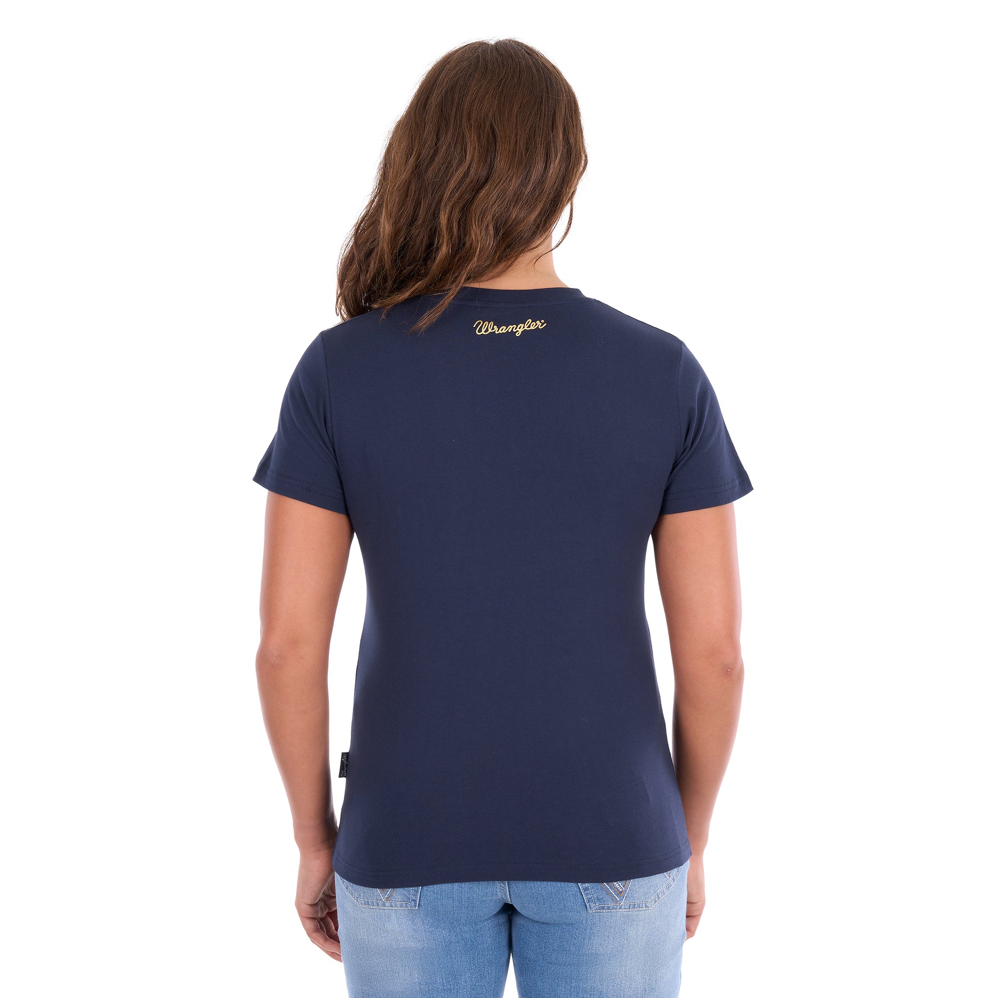 A woman viewed from behind modelling a navy blue Wrangler Belle Tee (X6S2598643) with a Wrangler logo on the back neck, paired with light blue jeans, against a plain white background.