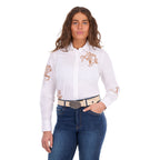 A woman modelling a white Wrangler Women's Darcy Long Sleeve Shirt (X6S2100606) with embroidered horse motifs on the chest and sleeves, paired with blue jeans and a Wrangler Zola Belt (XCP2918BLT) in Stone, against a plain white background.