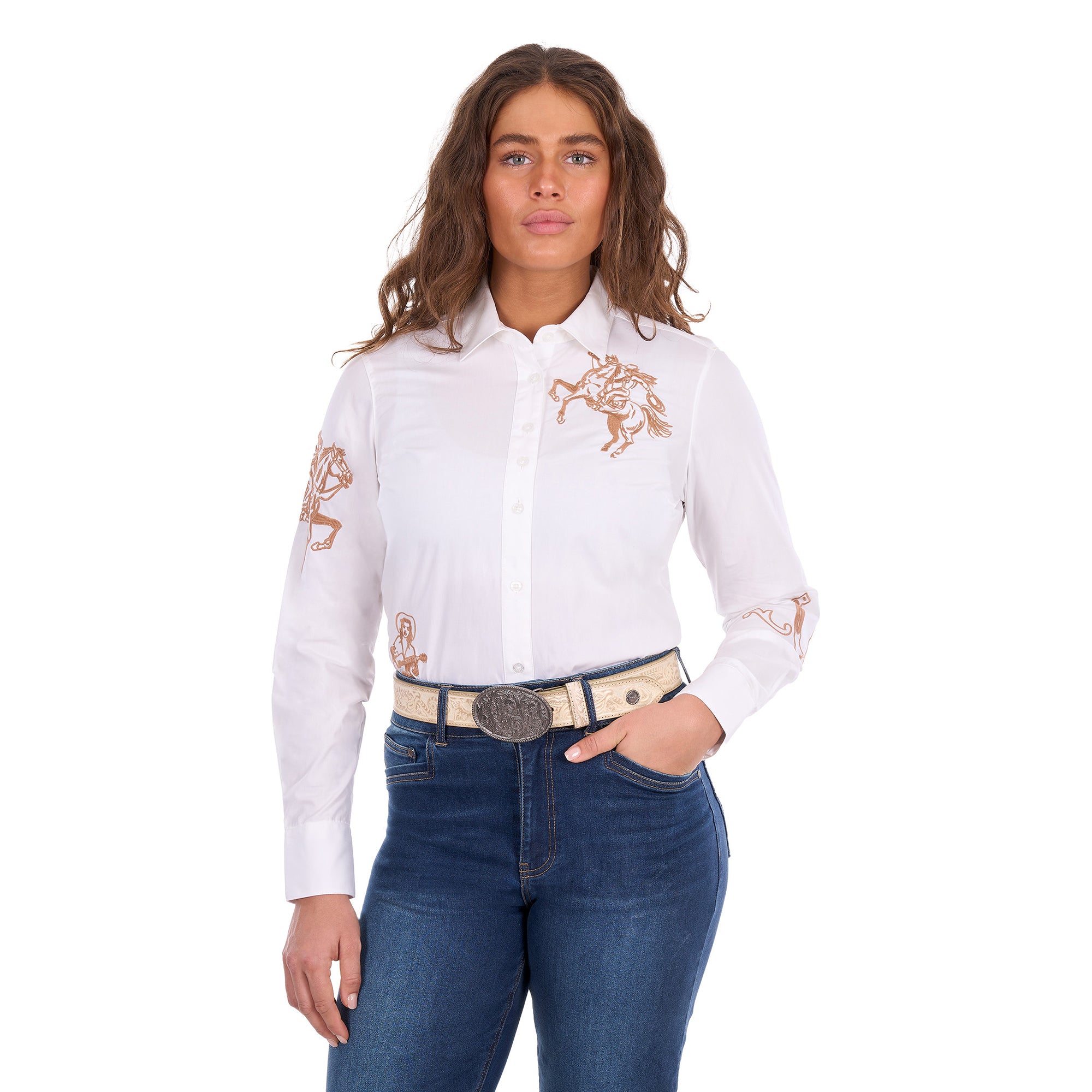 A woman modelling a white Wrangler Women's Darcy Long Sleeve Shirt (X6S2100606) with embroidered horse motifs on the chest and sleeves, paired with blue jeans and a Wrangler Zola Belt (XCP2918BLT) in Stone, against a plain white background.