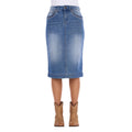 A Wrangler Women's Emmie Denim Skirt (X6S2410724) in light Kora Blue with embroidered pockets shown on a model from the waist down, paired with tan cowboy boots against a plain white background.