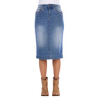 A Wrangler Women's Emmie Denim Skirt (X6S2410724) in light Kora Blue with embroidered pockets shown on a model from the waist down, paired with tan cowboy boots against a plain white background.