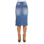 A Wrangler Women's Emmie Denim Skirt (X6S2410724) in light Kora Blue with embroidered pockets shown on a model from the waist down, from behind, paired with tan cowboy boots against a plain white background.