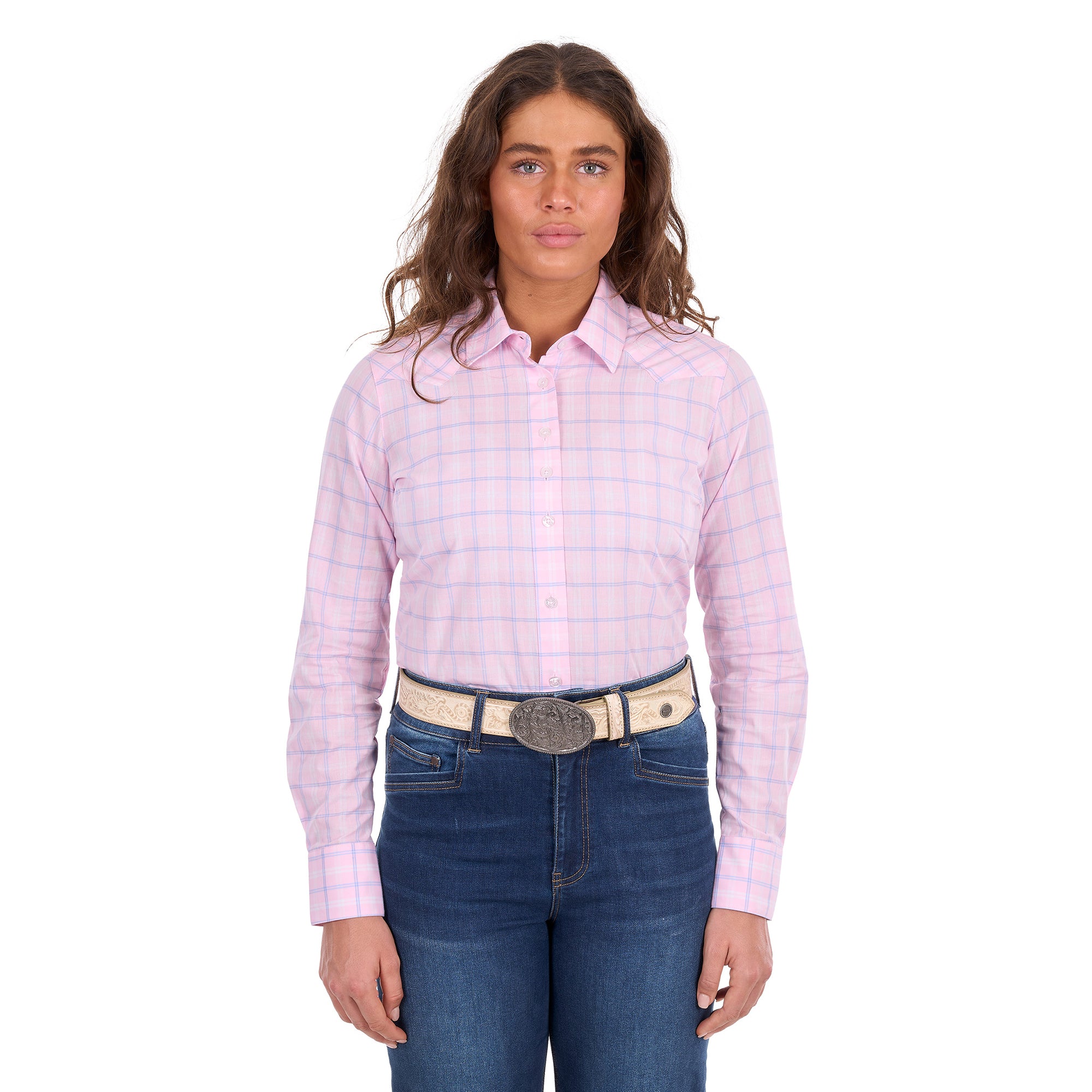 A woman in profile modelling a pink and blue Wrangler Women's Essie Long Sleeve Shirt (X6S2101601) with blue jeans and a western stone coloured Wrangler Zola Belt (XCP2918BLT), set against a plain white background.