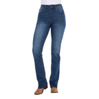 A woman wearing mid indigo blue western-style Wrangler Women's Etta Bootcut Jeans Bailey (XCP2255711) with a white top and tan boots, shown against a plain white background.
