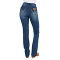 Rear view of a woman wearing mid indigo blue western-style Wrangler Women's Etta Bootcut Jeans Bailey (XCP2255711) with a white top and tan boots, shown against a plain white background.