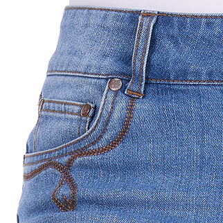 Close-up of a pair of faded blue Wrangler Women's Gigi Mid Rise Denim Shorts (XCP2411717) showing the front pocket, button, rivets, and contrast decorative stitching.