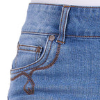 Close-up of a pair of faded blue Wrangler Women's Gigi Mid Rise Denim Shorts (XCP2411717) showing the front pocket, button, rivets, and contrast decorative stitching.