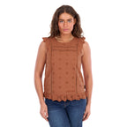 A woman modelling a copper Wrangler Women's Grace Sleeveless Blouse (X6S2502615) with eyelet embroidery and a ruffled hem, paired with blue jeans, against a plain white background.