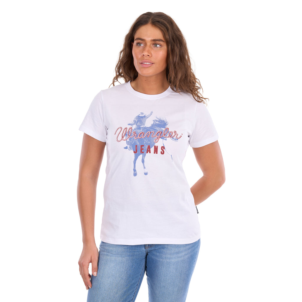 A woman wearing a white Wrangler Women's Gwen Tee (X6S2598635) t-shirt with a blue and red graphic print, paired with blue jeans, against a plain white background.