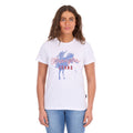 A woman modelling a white Wrangler Women's Gwen Tee (X6S2598635) t-shirt with a blue and red graphic on the front, paired with blue jeans, against a plain white background.