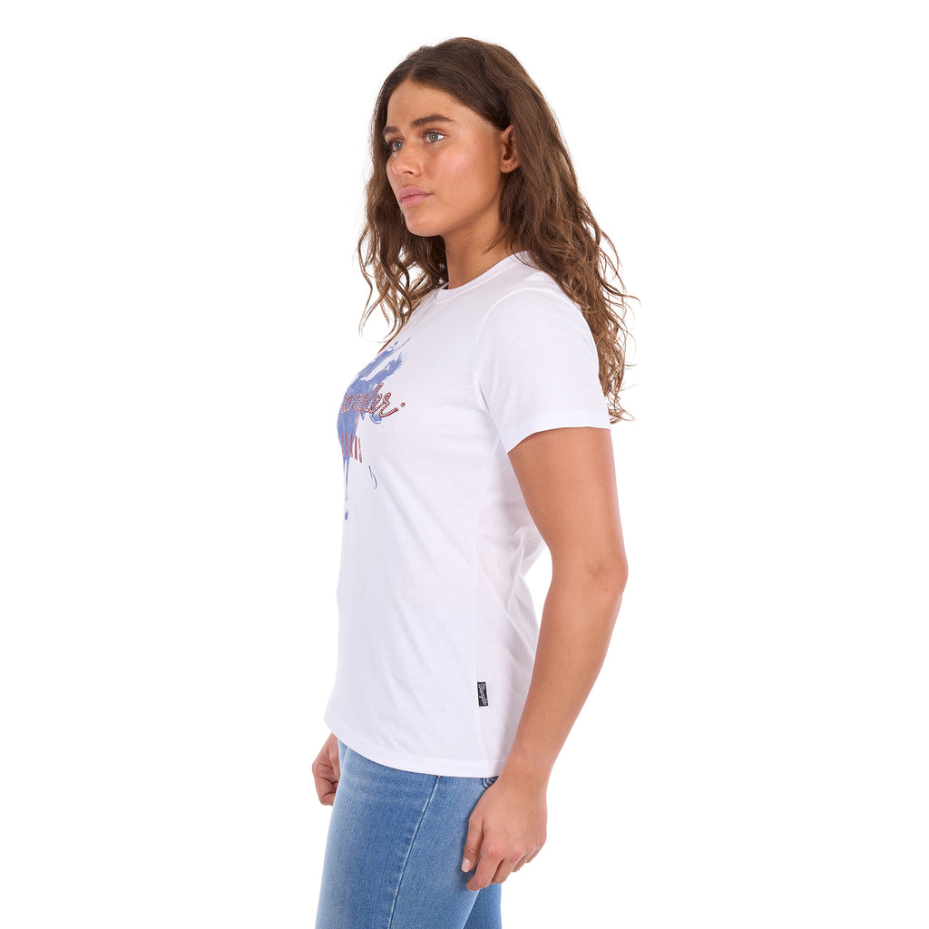 A woman wearing a white Wrangler Women's Gwen (X6S2598635) t-shirt with a blue and red graphic print on the front, paired with blue jeans, shown from a side profile against a plain white background.